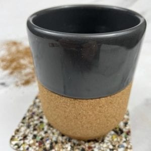 A picture of a cork and ceramic coffee mug with a cork