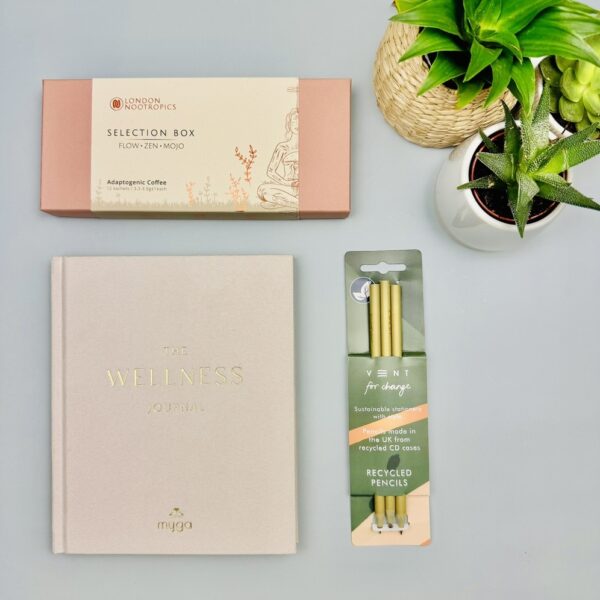 A picture of the journal gift her and shows the range of products that are included in the Nootropics Wellness Planner Gift Box.