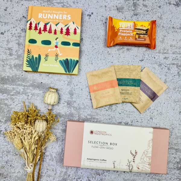 A picture of the gift for runner enthusiasts that includes a Mindful Thoughts for Runners book, Nootropics Coffee and a Tribe Protien Bar.